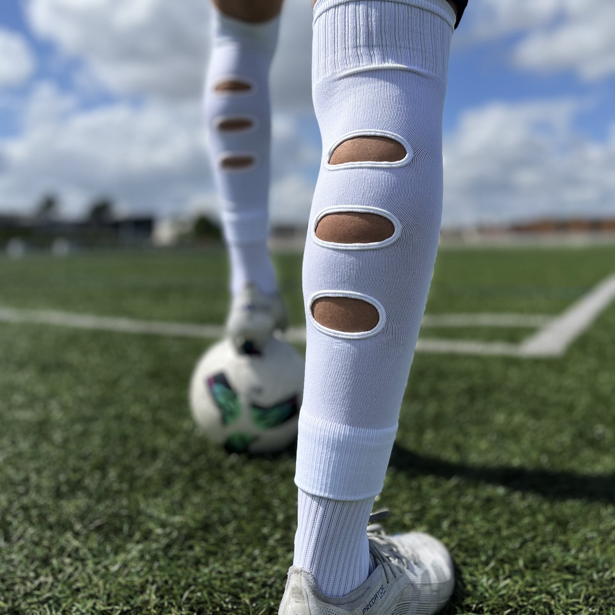 Chaussettes-a-trous-football, Manchons de football, precut socks ou jambières, couleur blanche, portées sur terrain de football | Game Changer